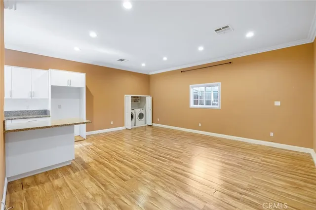 a view of a kitchen with a sink and a refrigerator