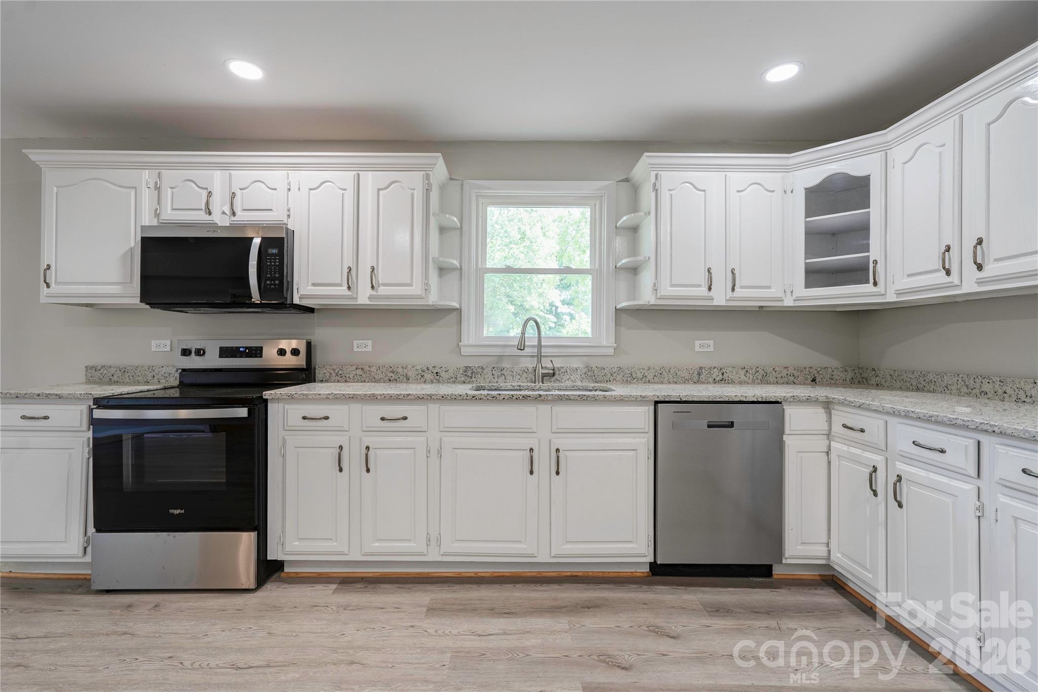 153 Greene Road Forest City, NC 28043 - Photo 13 of 23 a kitchen with granite countertop a sink stainless steel appliances and white cabinets