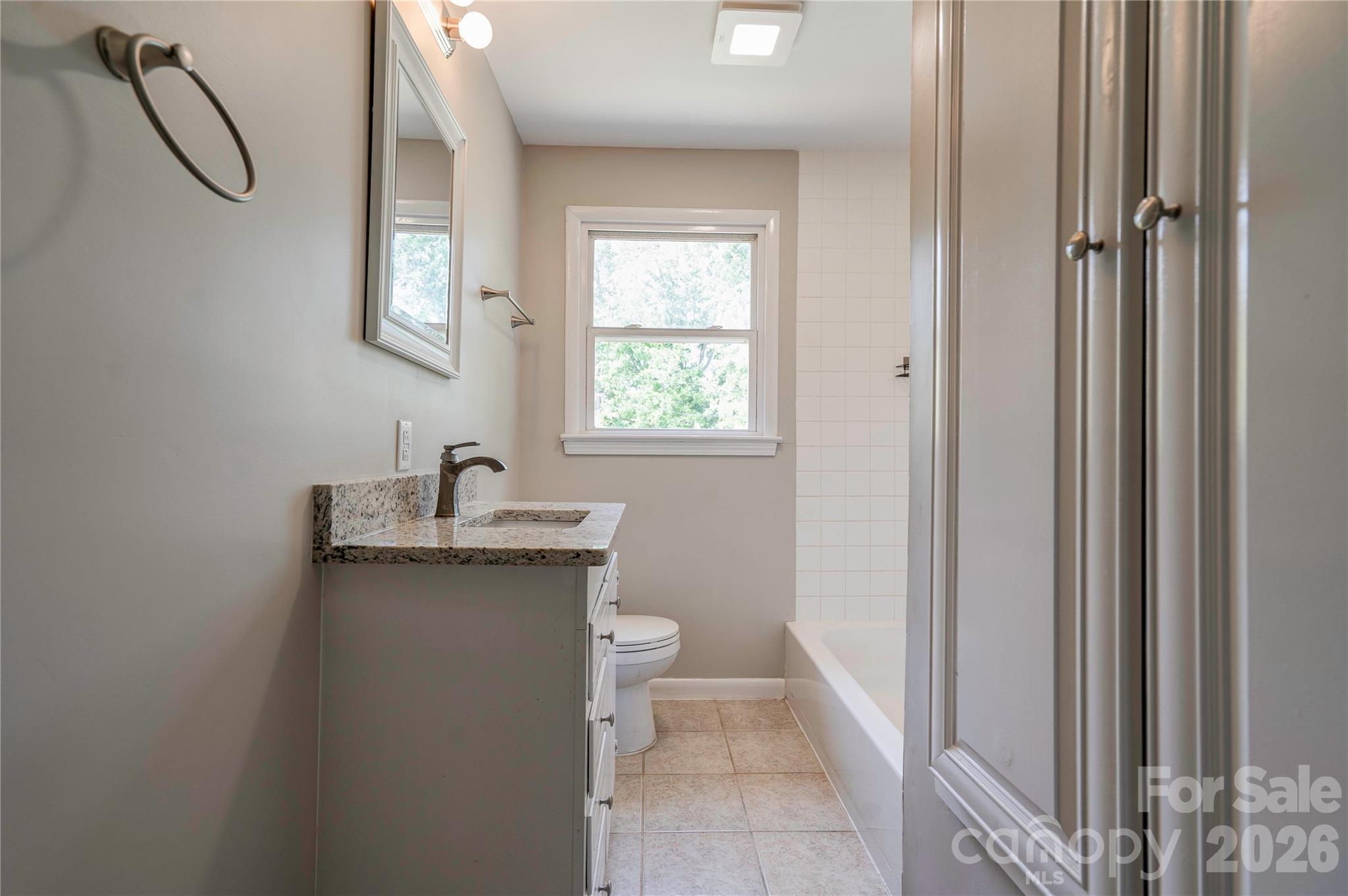 153 Greene Road Forest City, NC 28043 - Photo 17 of 23 a bathroom with a granite countertop sink a toilet and a shower