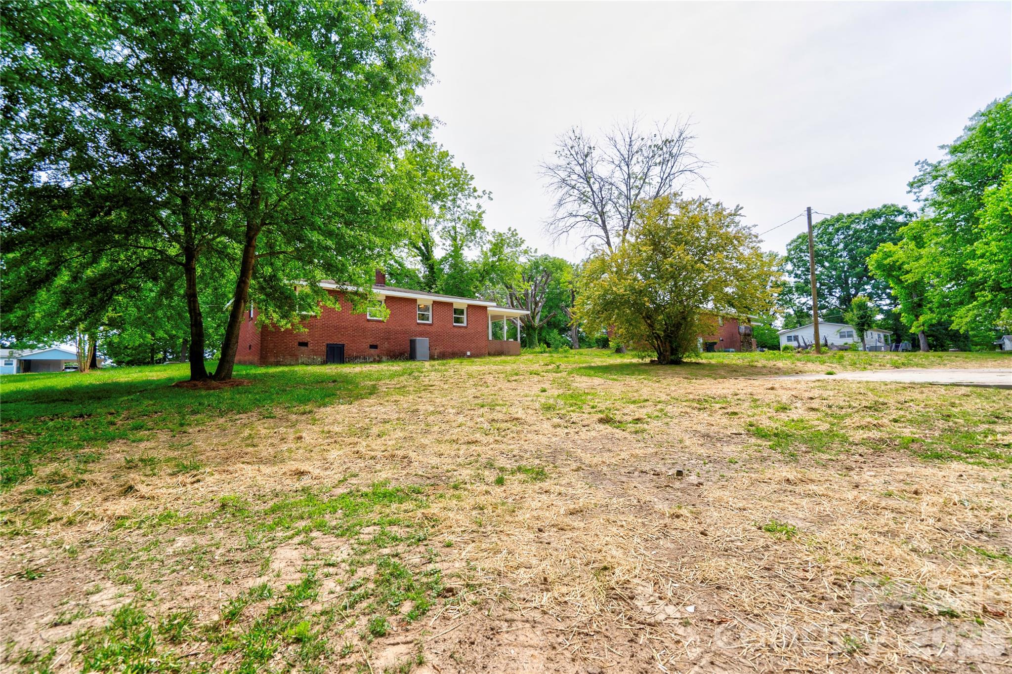 153 Greene Road Forest City, NC 28043 - Photo 5 of 23 a big yard with large trees