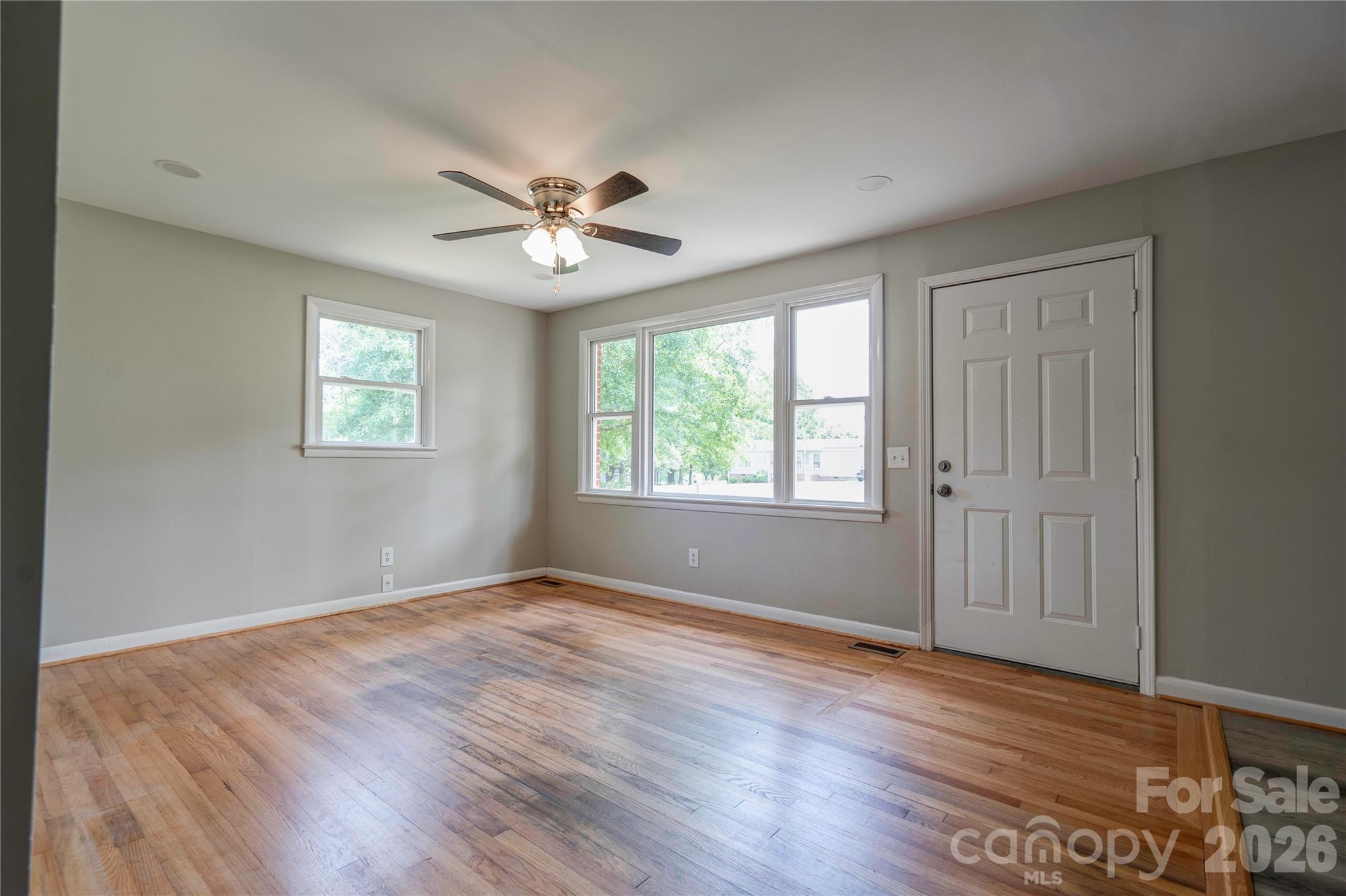 153 Greene Road Forest City, NC 28043 - Photo 8 of 23 a view of empty room with wooden floor and fan