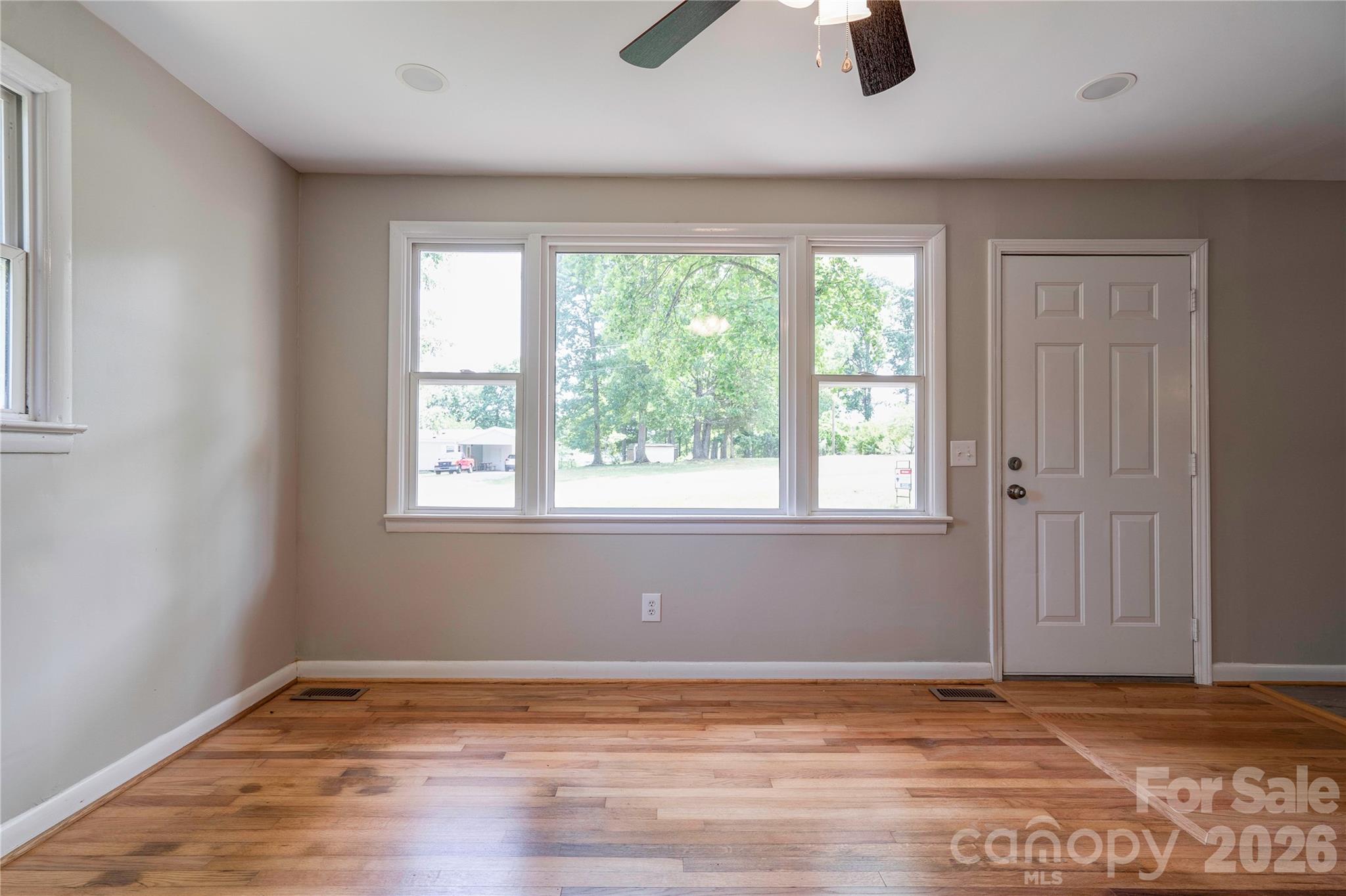 153 Greene Road Forest City, NC 28043 - Photo 9 of 23 a view of an empty room with window and wooden floor