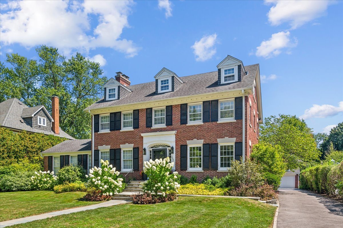 230 Oxford Road Kenilworth, IL 60043 - Photo 1 of 54 a front view of a house with garden