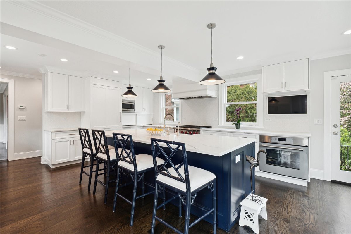 230 Oxford Road Kenilworth, IL 60043 - Photo 14 of 54 a kitchen with a table chairs sink and cabinets