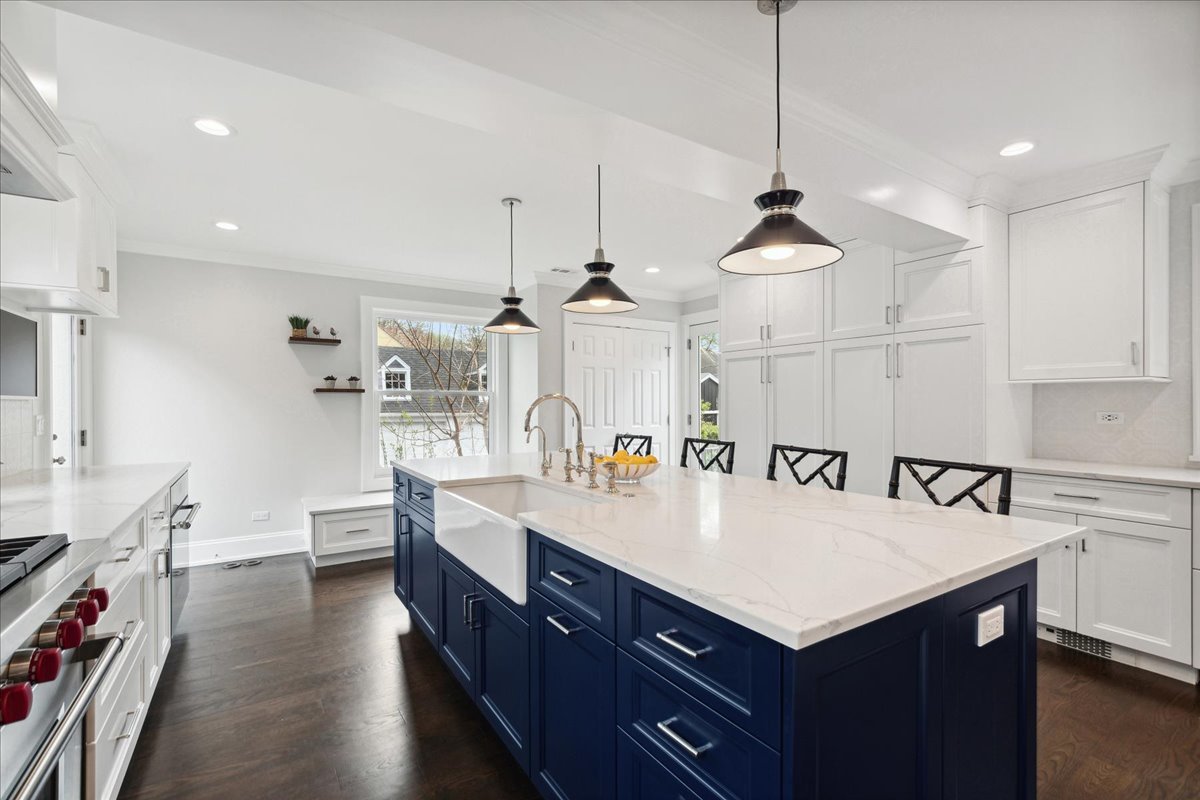 230 Oxford Road Kenilworth, IL 60043 - Photo 15 of 54 a large kitchen with stainless steel appliances a center island and a refrigerator