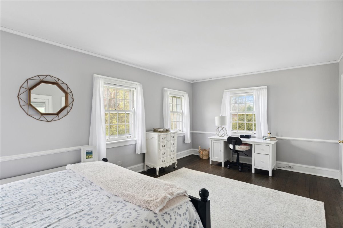 230 Oxford Road Kenilworth, IL 60043 - Photo 33 of 54 a bedroom with a bed a large window and a chandelier