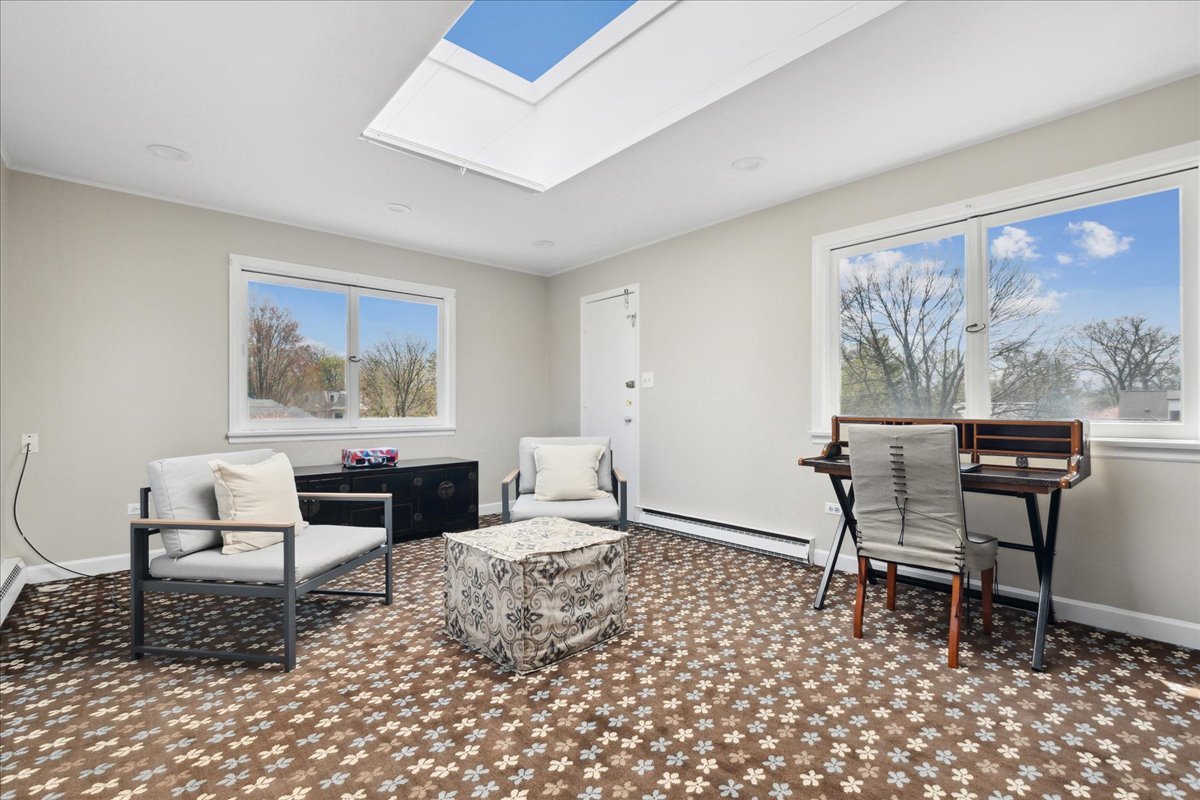 230 Oxford Road Kenilworth, IL 60043 - Photo 37 of 54 a work room with furniture a large window and a table