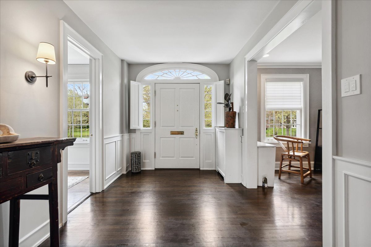 230 Oxford Road Kenilworth, IL 60043 - Photo 5 of 54 a view of a hallway with wooden floor and a living room