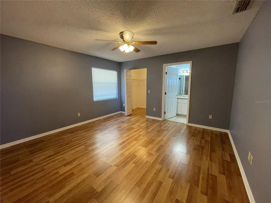 6034 East Peach Street Inverness, FL 34452 - Photo 11 of 16 a view of an empty room with wooden floor and a window