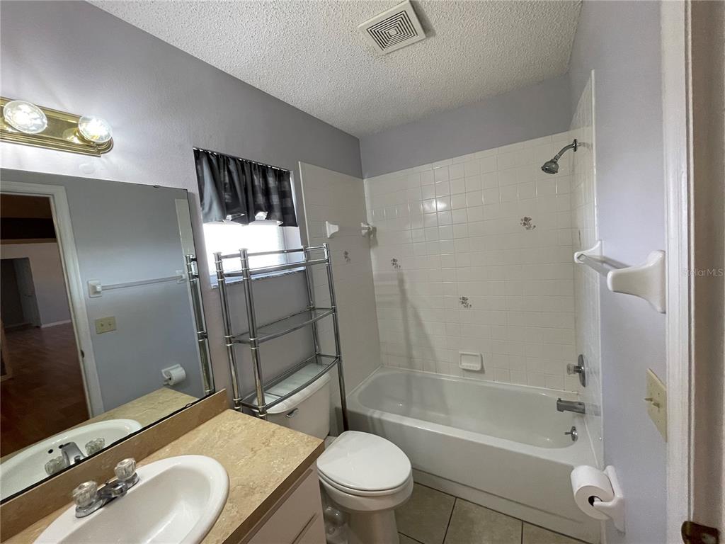 6034 East Peach Street Inverness, FL 34452 - Photo 14 of 16 a bathroom with a sink toilet and shower