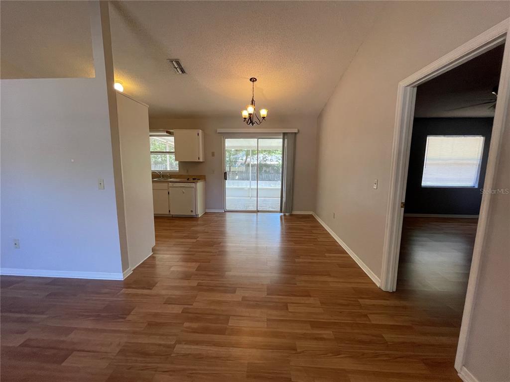6034 East Peach Street Inverness, FL 34452 - Photo 5 of 16 a view of a hallway with wooden floor and a kitchen