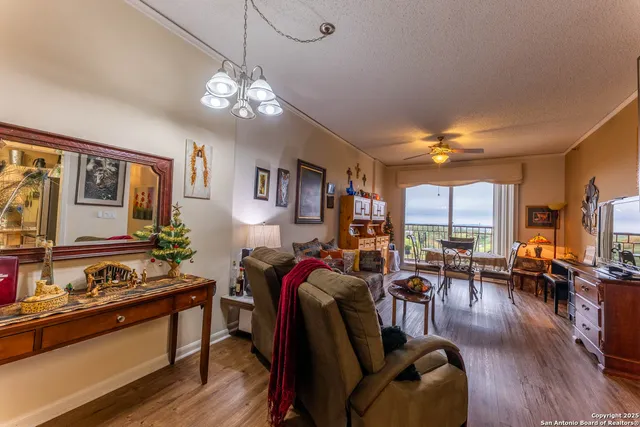 a living room with furniture kitchen view and a large window