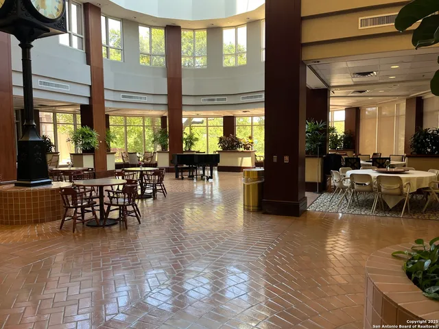 a room with lots of furniture and large windows