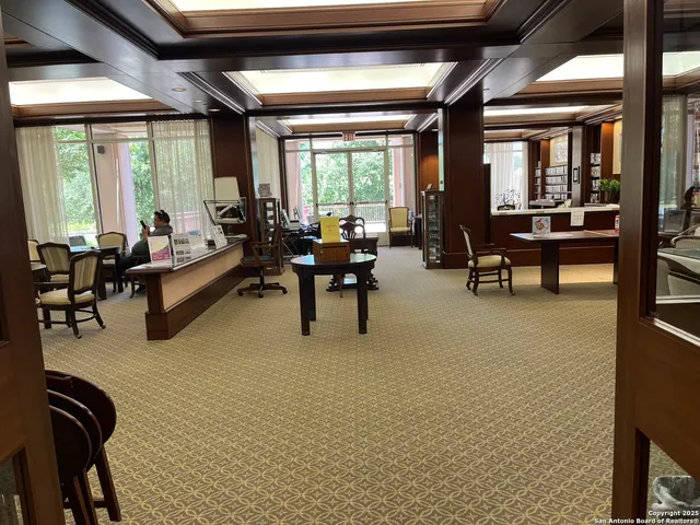 a room with pool table and windows