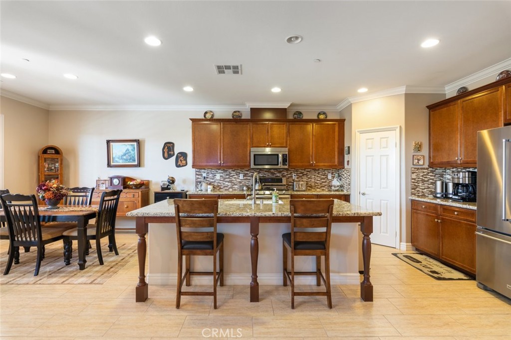 227 Tom McGuinness Jr Circle Fallbrook, CA 92028 - Photo 15 of 42 a large kitchen with a table and chairs