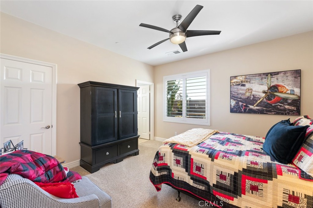227 Tom McGuinness Jr Circle Fallbrook, CA 92028 - Photo 19 of 42 a bedroom with a bed a dresser and window