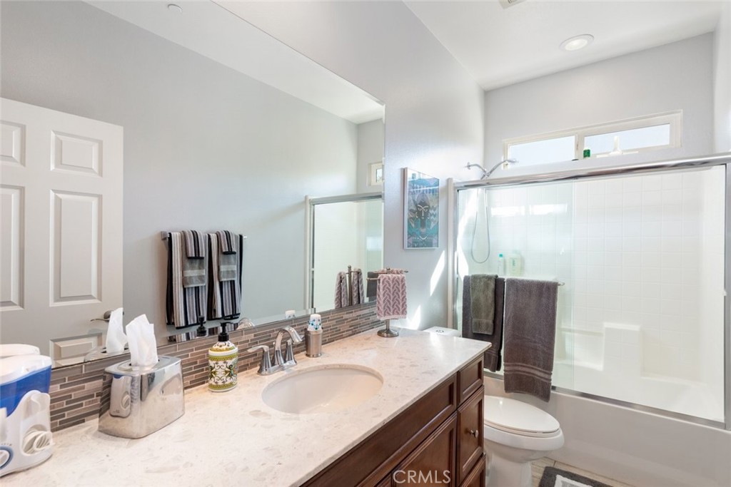 227 Tom McGuinness Jr Circle Fallbrook, CA 92028 - Photo 22 of 42 a bathroom with a granite countertop sink toilet and shower