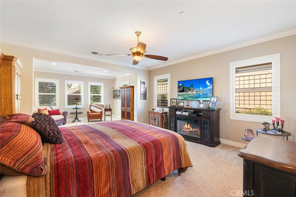 227 Tom McGuinness Jr Circle Fallbrook, CA 92028 - Photo 24 of 42 a spacious bedroom with a bed and a flat screen tv
