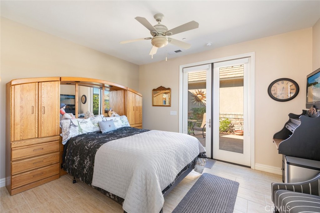 227 Tom McGuinness Jr Circle Fallbrook, CA 92028 - Photo 27 of 42 a bedroom with a large bed and a large window