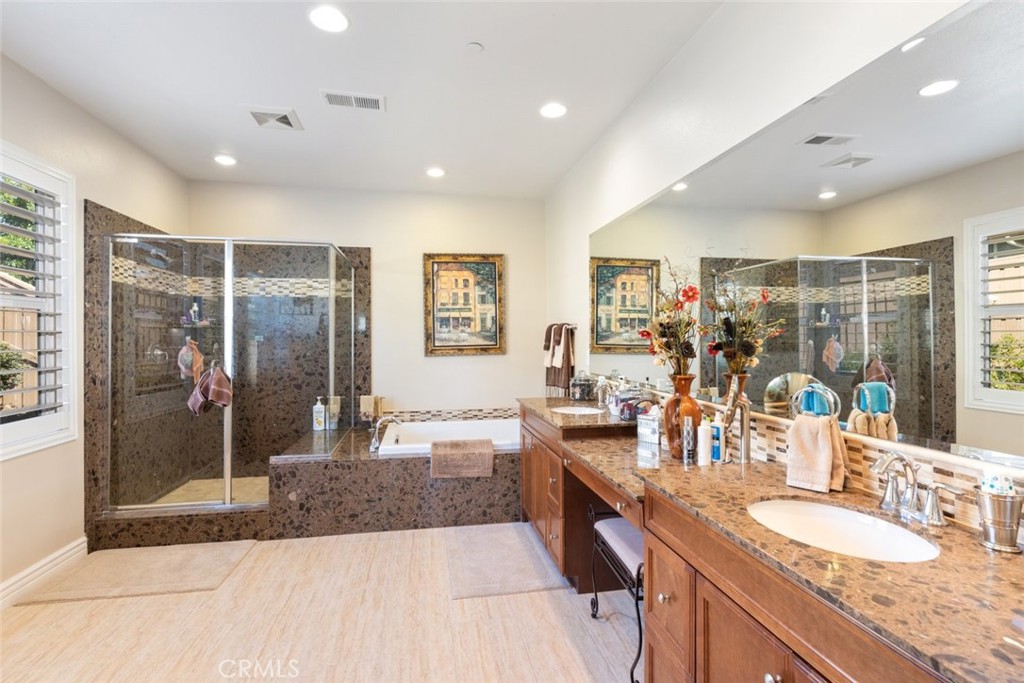 227 Tom McGuinness Jr Circle Fallbrook, CA 92028 - Photo 28 of 42 a large bathroom with double vanity sinks a large mirror and a shower