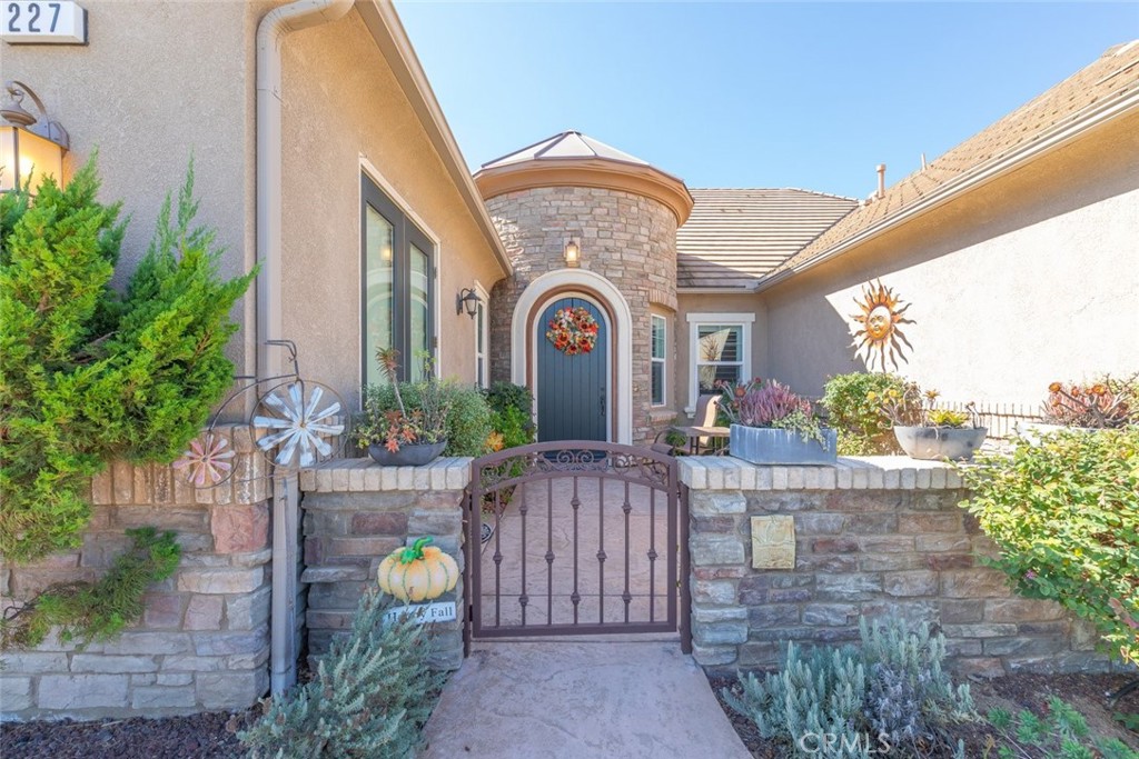 227 Tom McGuinness Jr Circle Fallbrook, CA 92028 - Photo 6 of 42 a view of a building entryway with flower plants
