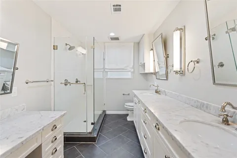 a bedroom with a bed and a flat tv screen on dresser