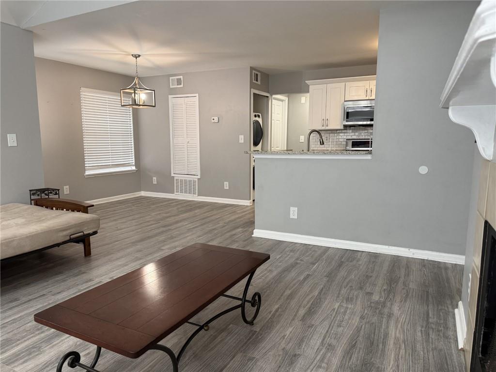 105 Hawkstone Way Alpharetta, GA 30022 - Photo 7 of 23 a living room with dining room and kitchen view