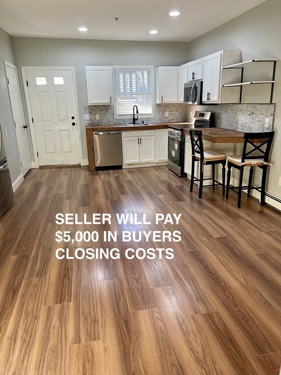 a large kitchen with lots of counter space a sink and appliances
