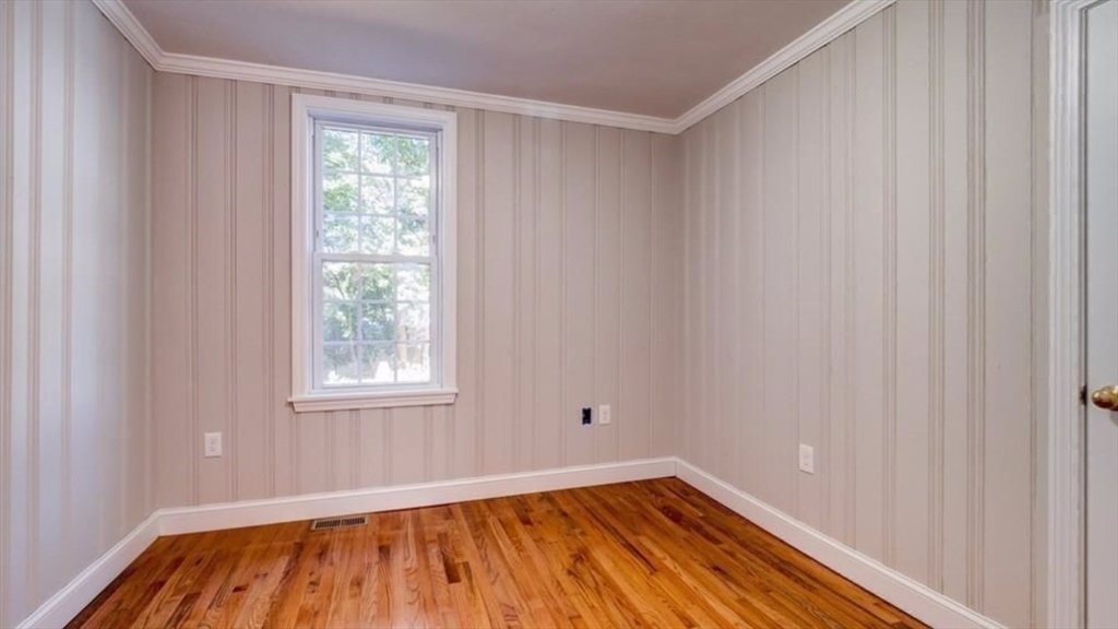 2 C Street Douglas, MA 01516 - Photo 20 of 27 a view of an empty room with wooden floor and a window