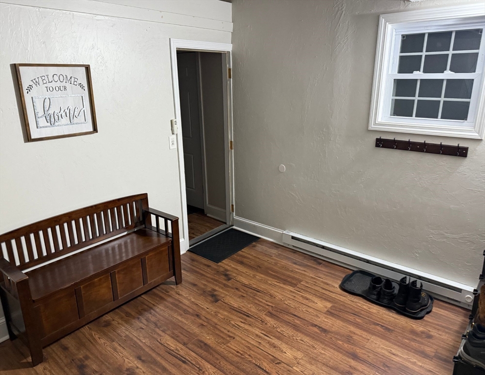 2 C Street Douglas, MA 01516 - Photo 8 of 27 a view of an empty room with wooden floor and a window
