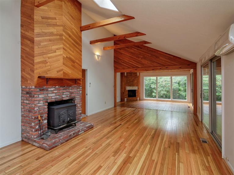 288 Huckins Neck Road Centerville, MA 02601 - Photo 7 of 18 a view of empty room with wooden floor and fireplace
