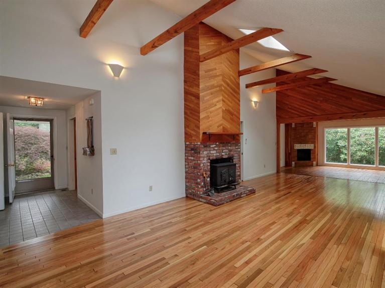 288 Huckins Neck Road Centerville, MA 02601 - Photo 8 of 18 a view of empty room with wooden floor and fireplace
