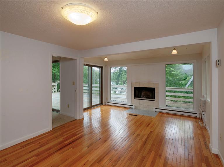 288 Huckins Neck Road Centerville, MA 02601 - Photo 9 of 18 wooden floor fireplace and natural light in room