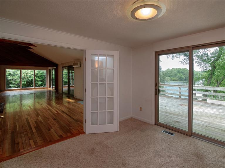 288 Huckins Neck Road Centerville, MA 02601 - Photo 10 of 18 an empty room with floor to ceiling windows and wooden floor