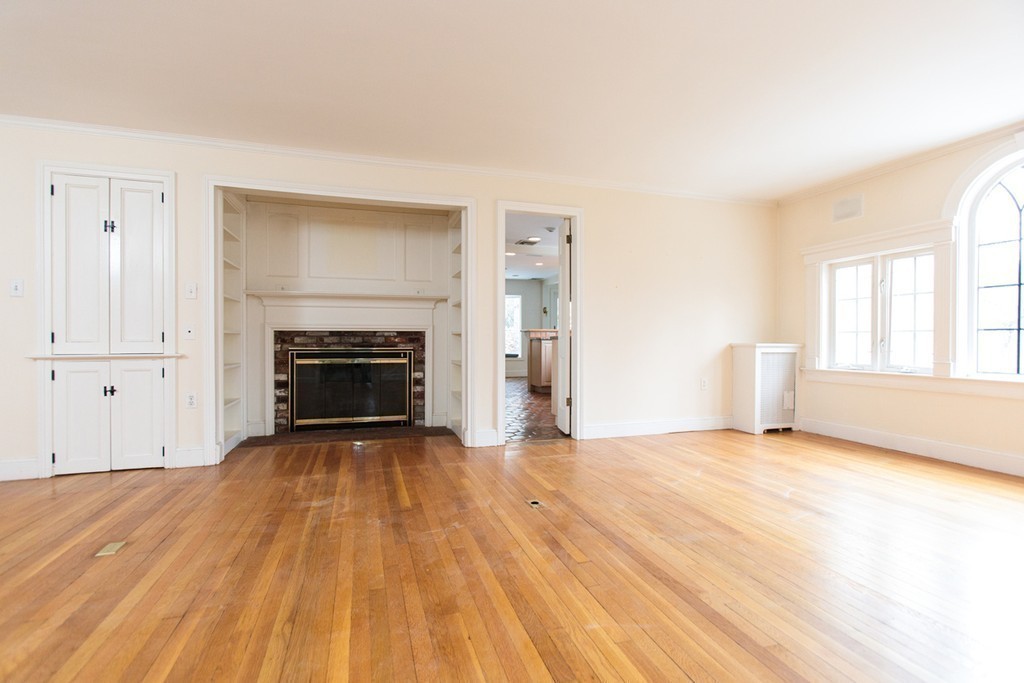50 Lincoln Road Wellesley, MA 02481 - Photo 6 of 16 a view of empty room with wooden floor and fireplace