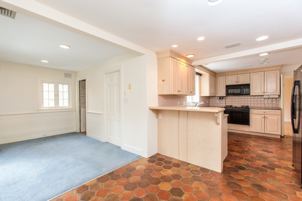 50 Lincoln Road Wellesley, MA 02481 - Photo 8 of 16 a kitchen with granite countertop a stove top oven and cabinets