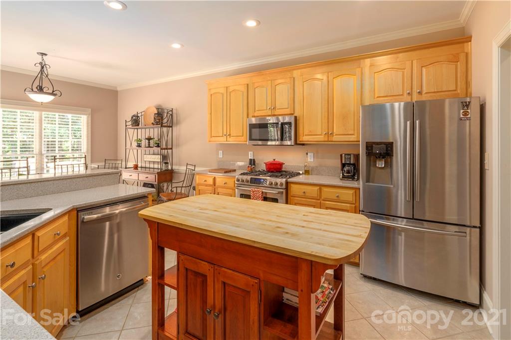 6607 Fox Ridge Circle Davidson, NC 28036 - Photo 11 of 48 a kitchen with stainless steel appliances granite countertop a refrigerator a sink dishwasher a stove with white cabinets and wooden floor