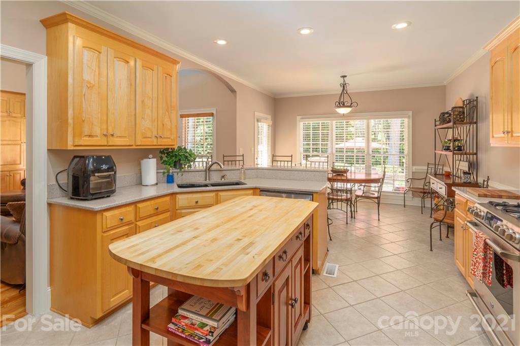 6607 Fox Ridge Circle Davidson, NC 28036 - Photo 13 of 48 a large kitchen with kitchen island a stove a sink a counter space and dining table view