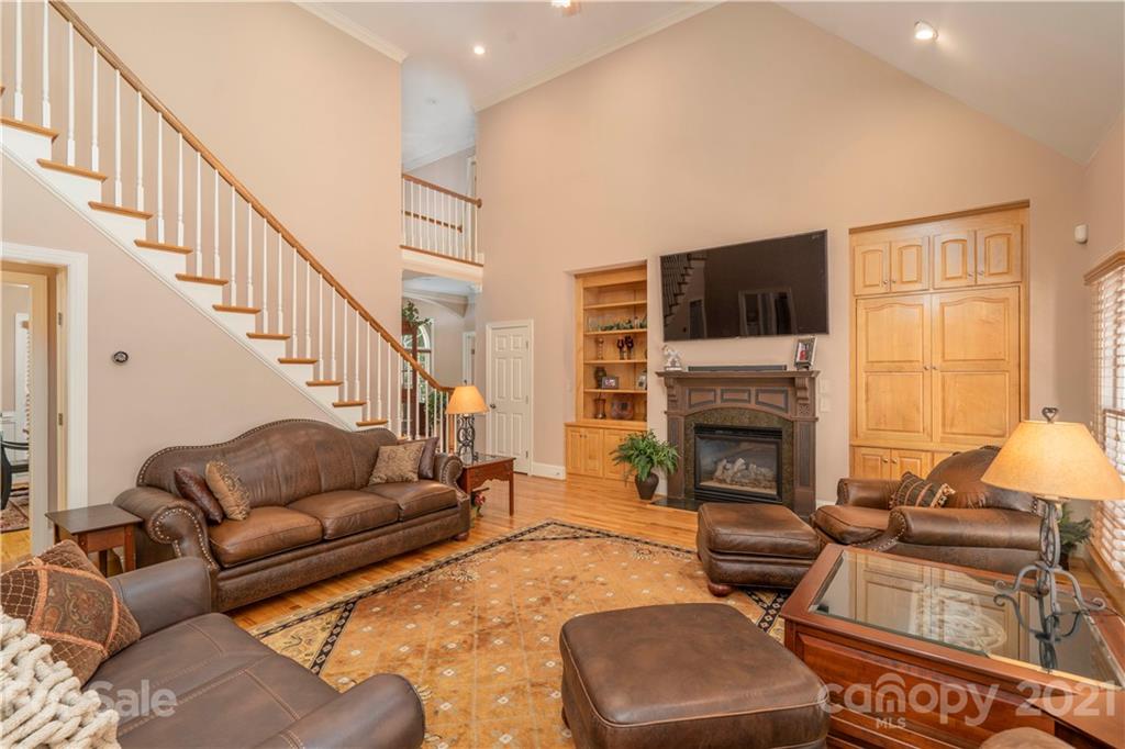 6607 Fox Ridge Circle Davidson, NC 28036 - Photo 21 of 48 a living room with furniture fireplace and a flat screen tv