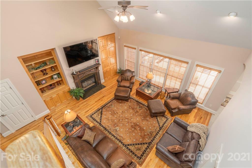 6607 Fox Ridge Circle Davidson, NC 28036 - Photo 22 of 48 a living room with furniture a flat screen tv and a floor to ceiling window