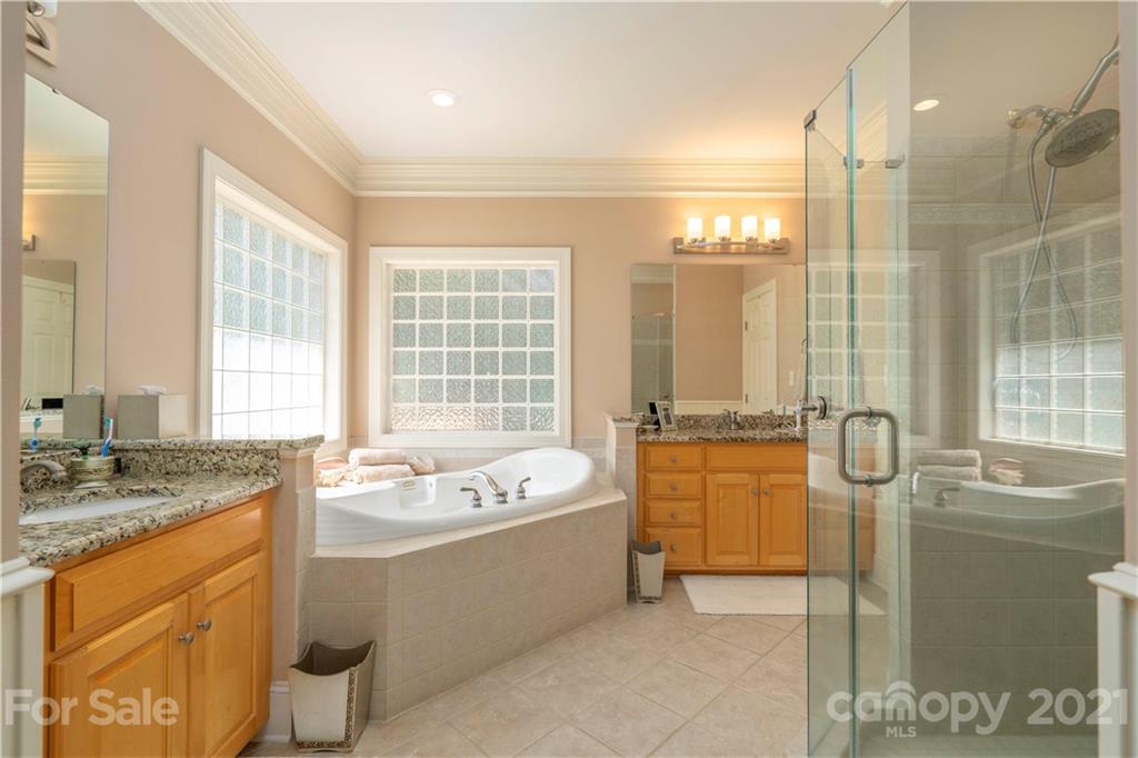 6607 Fox Ridge Circle Davidson, NC 28036 - Photo 24 of 48 a bathroom with a granite countertop tub sink and mirror