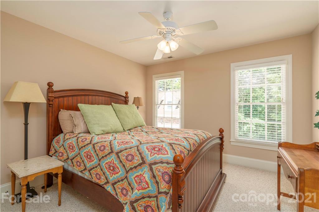 6607 Fox Ridge Circle Davidson, NC 28036 - Photo 27 of 48 a bedroom with a bed and a chandelier