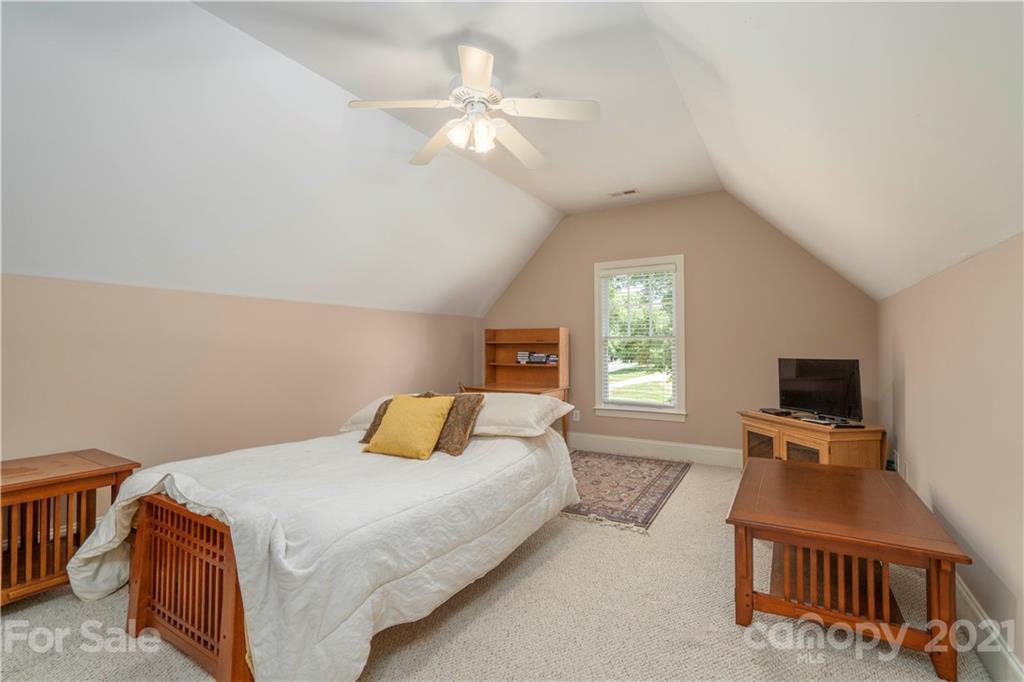 6607 Fox Ridge Circle Davidson, NC 28036 - Photo 28 of 48 a bedroom with a bed and a flat screen tv