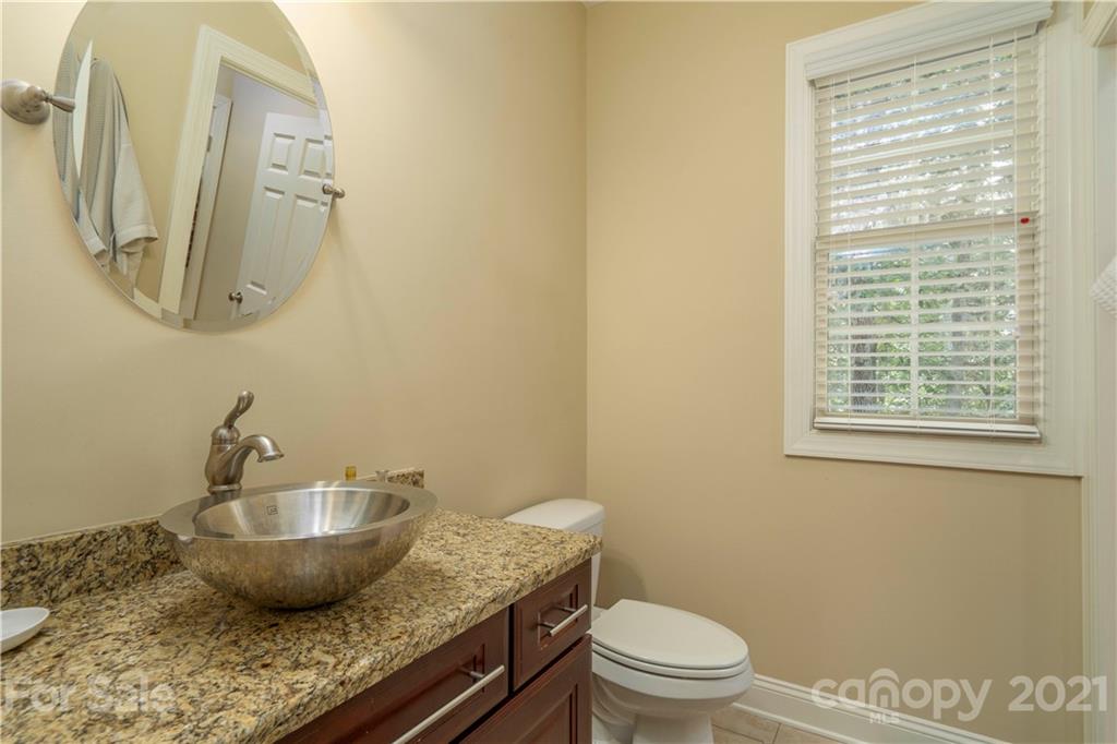 6607 Fox Ridge Circle Davidson, NC 28036 - Photo 39 of 48 a bathroom with a granite countertop sink mirror vanity and toilet