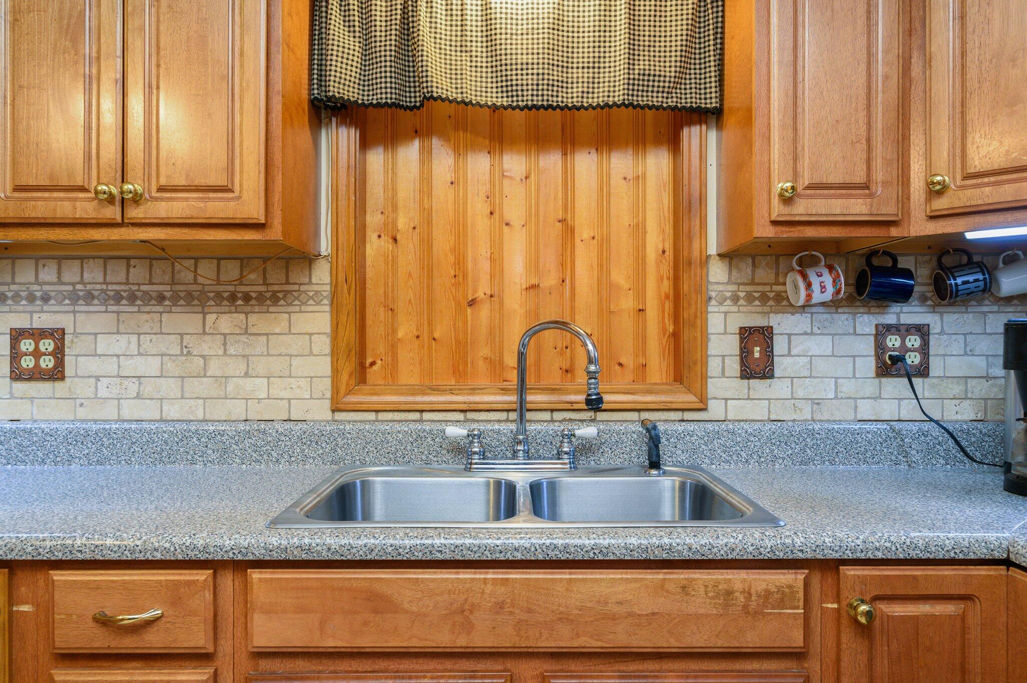 52 Tulip Avenue DeFuniak Springs, FL 32433 - Photo 16 of 34 a kitchen with granite countertop stainless steel appliances a sink and a counter top space