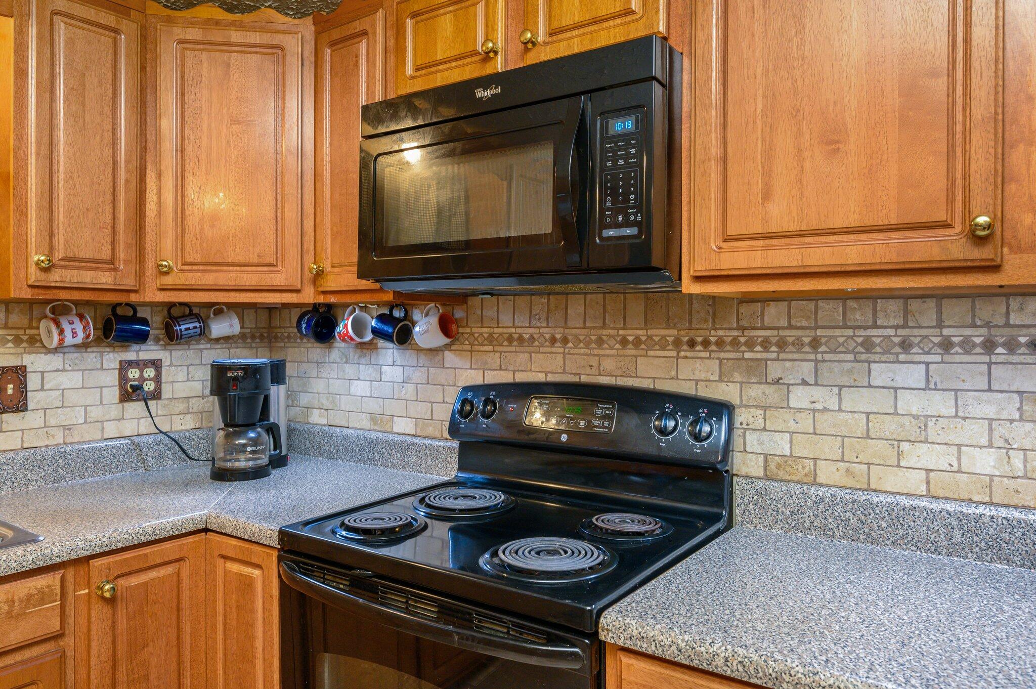 52 Tulip Avenue DeFuniak Springs, FL 32433 - Photo 17 of 34 a kitchen with a stove and a microwave