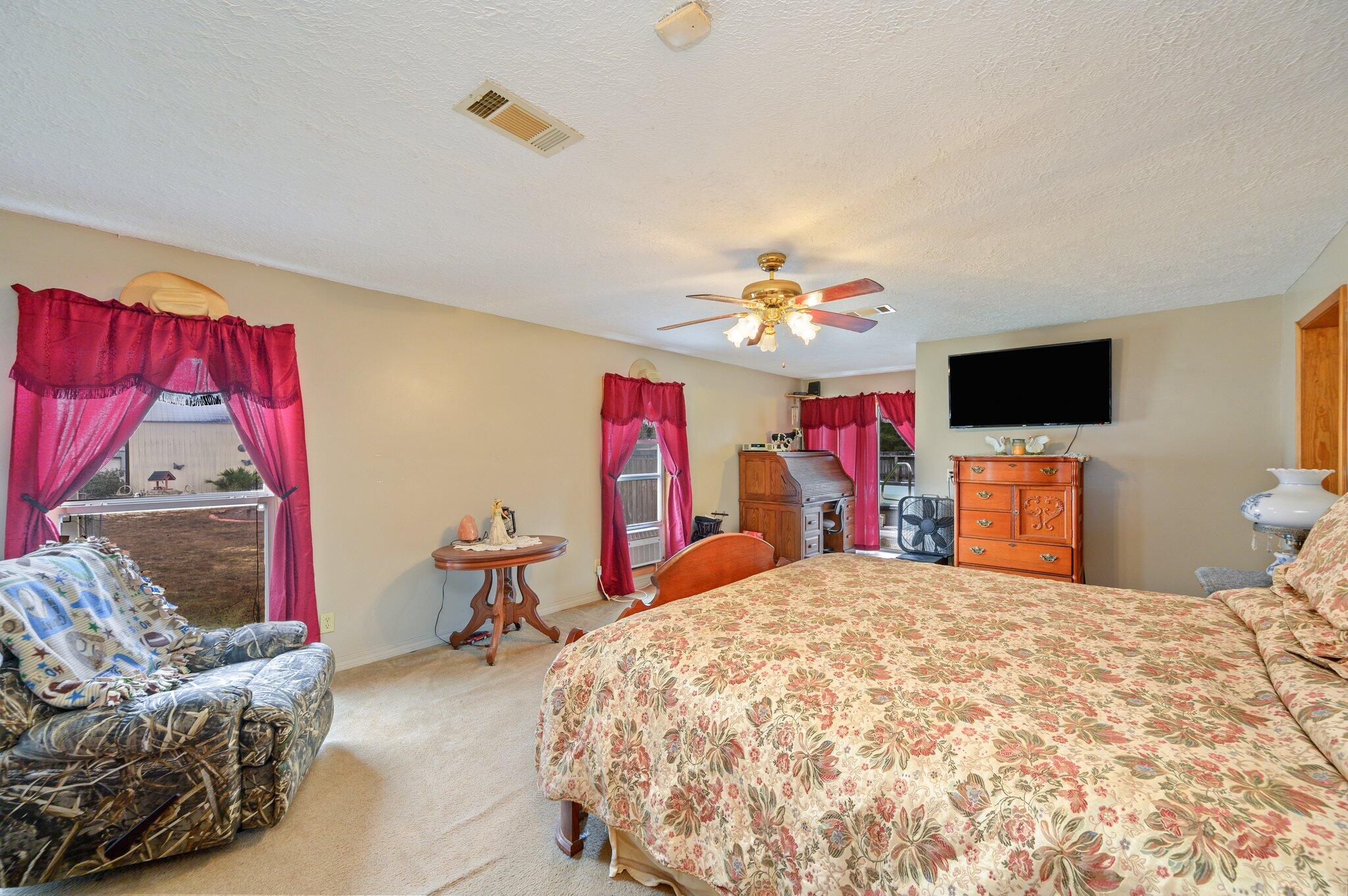 52 Tulip Avenue DeFuniak Springs, FL 32433 - Photo 20 of 34 a bedroom with a bed and a flat screen tv