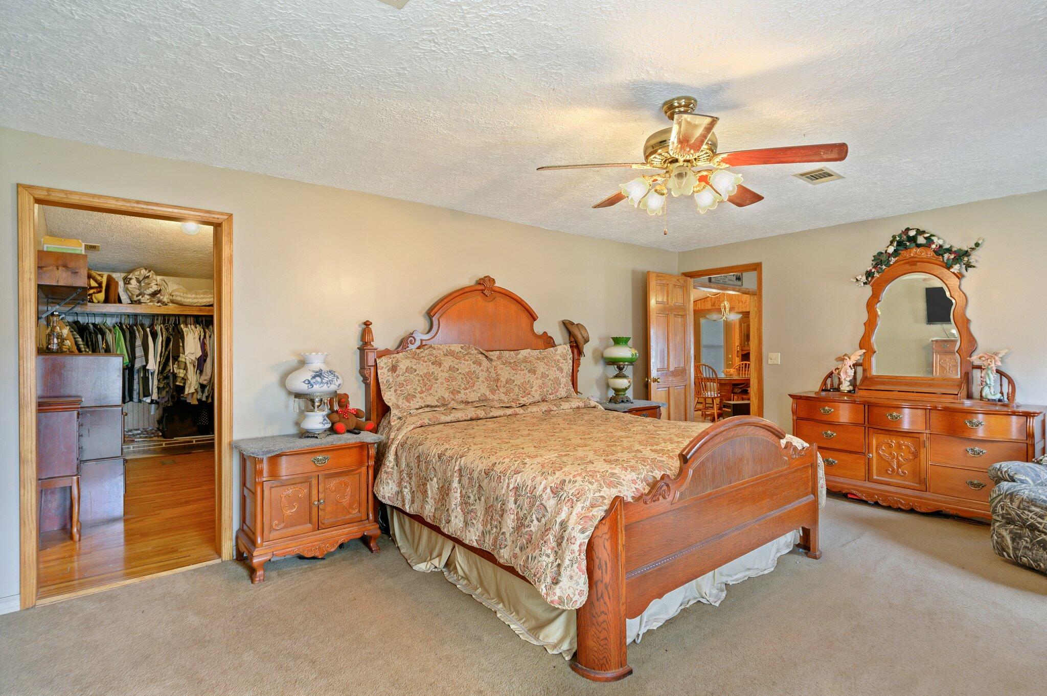 52 Tulip Avenue DeFuniak Springs, FL 32433 - Photo 21 of 34 a bedroom with a bed and a chandelier