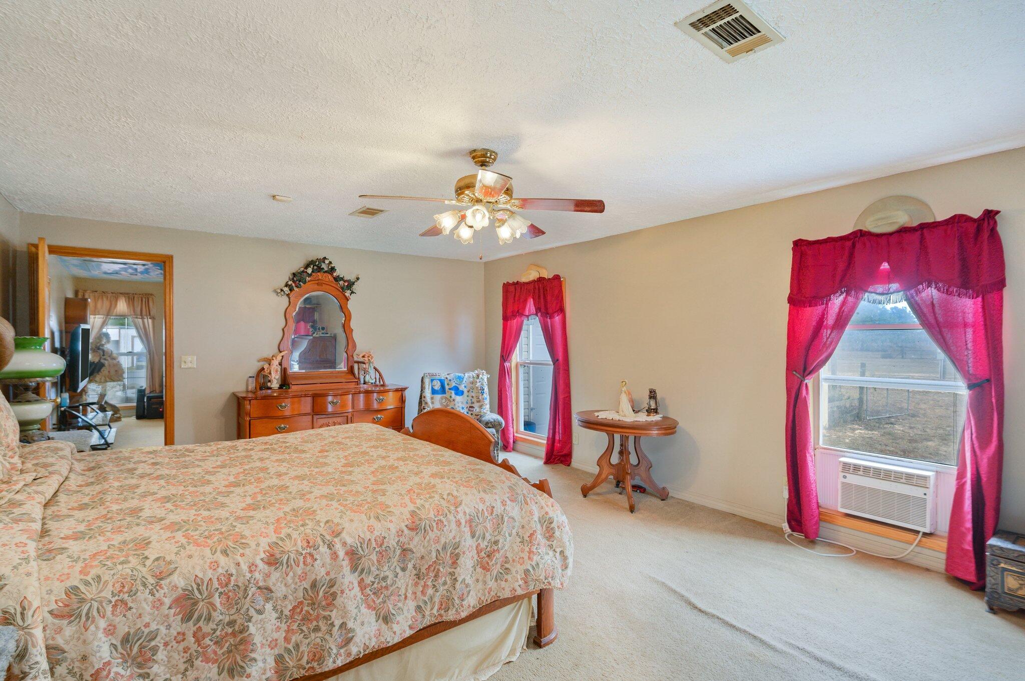 52 Tulip Avenue DeFuniak Springs, FL 32433 - Photo 22 of 34 a bedroom with a bed and a chandelier