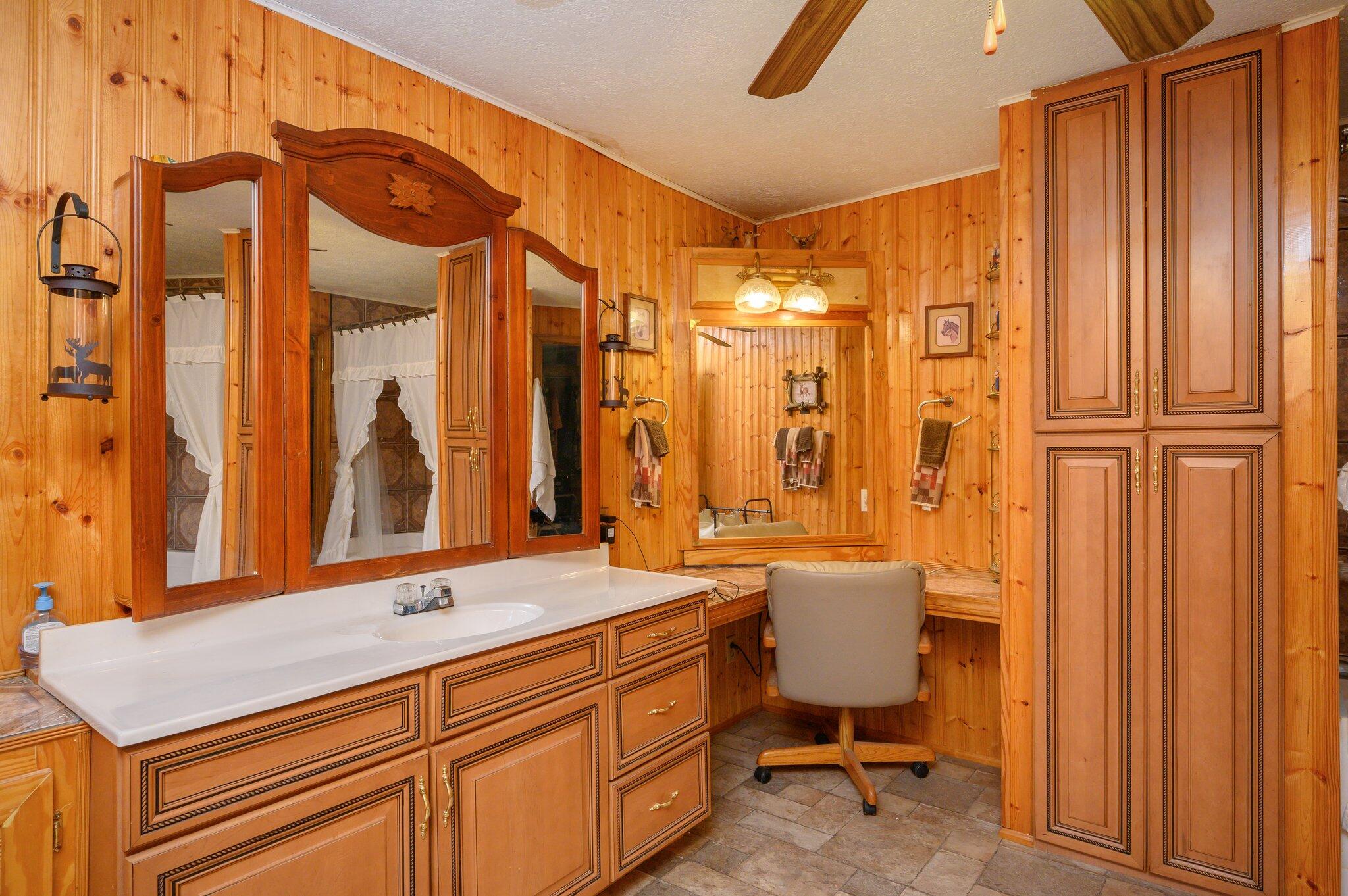 52 Tulip Avenue DeFuniak Springs, FL 32433 - Photo 23 of 34 a bathroom with a sink a mirror and a shower
